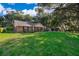 Beautiful brick home with dark shutters, a green lawn, and mature trees in a desirable neighborhood at 493 Princewood Dr, Deland, FL 32724