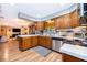 Traditional kitchen with wooden cabinets, stainless steel appliances, and hardwood floors at 493 Princewood Dr, Deland, FL 32724