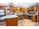 Traditional kitchen with wooden cabinets, stainless steel appliances, and hardwood floors at 493 Princewood Dr, Deland, FL 32724