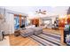 Bright living room featuring wood-look floors, a ceiling fan, a fireplace, and sliding glass doors to the outside at 493 Princewood Dr, Deland, FL 32724