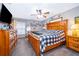 Comfortable main bedroom boasts wooden furniture and is bathed in natural light from the window, creating a relaxing retreat at 493 Princewood Dr, Deland, FL 32724