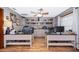 Bright office space with two work stations, wood-look flooring, and built-in shelves for storage and organization at 493 Princewood Dr, Deland, FL 32724