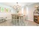 Cozy eat-in kitchen featuring a modern light fixture and room for four at the kitchen table at 4963 Hoperita St, Orlando, FL 32812