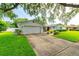 Attractive single-story home with a spacious driveway, lush lawn, and inviting front porch at 4963 Hoperita St, Orlando, FL 32812