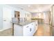 Bright kitchen featuring granite countertops, stainless steel appliances and a center island with bar stool seating at 4963 Hoperita St, Orlando, FL 32812