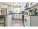 Modern kitchen featuring white cabinets, granite countertops, stainless steel appliances, and sleek, modern hardware at 4963 Hoperita St, Orlando, FL 32812