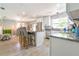 Bright kitchen featuring granite countertops, stainless steel appliances and a center island with bar stool seating at 4963 Hoperita St, Orlando, FL 32812