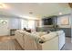 Inviting living room featuring a sectional sofa, custom built-ins, and ample natural light at 4963 Hoperita St, Orlando, FL 32812