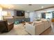 Stylish living room featuring a comfortable sectional sofa, modern entertainment center, and open layout at 4963 Hoperita St, Orlando, FL 32812