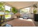 Enclosed lanai offering patio furniture, a view of the fenced yard, and access to the refreshing pool area at 4963 Hoperita St, Orlando, FL 32812