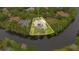 Waterfront home with mature trees and a private pool. Aerial view highlights property lines at 5241 Vista Club Run, Sanford, FL 32771