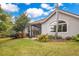 Serene backyard featuring a screened lanai, lush landscaping, and seamless integration with the home's architecture at 5241 Vista Club Run, Sanford, FL 32771