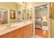 Bathroom featuring double sinks, wood cabinets and bedroom view at 5241 Vista Club Run, Sanford, FL 32771
