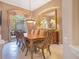 Elegant dining room featuring a large window, decorative mirror, and a chandelier at 5241 Vista Club Run, Sanford, FL 32771