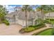 Elegant home boasts a well-manicured landscape, driveway, and a spacious three-car garage at 5241 Vista Club Run, Sanford, FL 32771