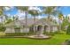Stately home with manicured lawn, decorative fountain, and elegant architectural details at 5241 Vista Club Run, Sanford, FL 32771