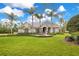 Stunning home featuring lush lawn, mature palms, circular driveway, and fountain at 5241 Vista Club Run, Sanford, FL 32771