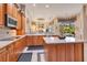 Spacious kitchen with wood cabinetry, island, modern appliances, and adjacent living area at 5241 Vista Club Run, Sanford, FL 32771
