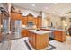 Gourmet kitchen with custom wood cabinets, stainless appliances, and center island at 5241 Vista Club Run, Sanford, FL 32771
