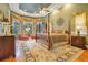 Spacious main bedroom with four-poster bed, sitting area, and large windows with drapes at 5241 Vista Club Run, Sanford, FL 32771