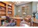 Home office with wooden bookshelves, desk, and comfortable leather chairs at 5241 Vista Club Run, Sanford, FL 32771