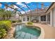 Gorgeous screened-in pool area with rock features, tropical plants, and a seamless transition to indoor living at 5241 Vista Club Run, Sanford, FL 32771