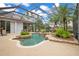 Beautiful screened-in pool area with lush landscaping and outdoor dining at 5241 Vista Club Run, Sanford, FL 32771