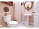 Cozy powder room with pedestal sink, toilet, and decorative mirror at 5241 Vista Club Run, Sanford, FL 32771