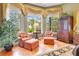 Comfortable sitting area with plush armchairs, ottomans, and a large window at 5241 Vista Club Run, Sanford, FL 32771