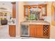 Wet bar with wine refrigerator, cabinet storage, and sink, adjacent to living area at 5241 Vista Club Run, Sanford, FL 32771