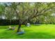 The expansive backyard includes a swing, playhouse, and trampoline, providing ample space for Gathering fun and recreation at 5351 Carson St, St Cloud, FL 34771