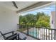 Relaxing balcony with a view of the pool, mature trees and a lush green lawn at 5351 Carson St, St Cloud, FL 34771