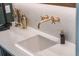 Close-up of a wet bar showcasing the marble countertop and stylish gold fixtures at 5351 Carson St, St Cloud, FL 34771