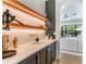 Chic bar area with a marble countertop, sleek cabinetry, and elegant lighting, perfect for entertaining at 5351 Carson St, St Cloud, FL 34771