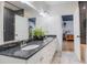 Bathroom with a double vanity featuring granite countertops, two sinks, and a tiled floor at 5351 Carson St, St Cloud, FL 34771