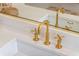 Close up of modern brushed gold bathroom sink faucet at 5351 Carson St, St Cloud, FL 34771