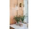 Close-up of a bathroom vanity with brushed gold fixtures, quartz counters, and modern glass sconces at 5351 Carson St, St Cloud, FL 34771
