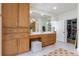 Bright bathroom featuring custom cabinets, spacious vanity, and a door leading to a walk-in closet at 5351 Carson St, St Cloud, FL 34771