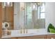 Modern bathroom with a frameless mirror reflecting the shower with brushed gold fixtures at 5351 Carson St, St Cloud, FL 34771