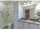 Bathroom with a glass-enclosed shower, a granite-topped vanity, and modern light blue cabinets at 5351 Carson St, St Cloud, FL 34771