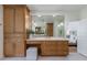 Bright bathroom featuring custom cabinets, spacious vanity, and large mirror with stylish lighting at 5351 Carson St, St Cloud, FL 34771