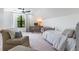 Bright bedroom with a desk area, ceiling fan, and a large window with natural lighting at 5351 Carson St, St Cloud, FL 34771