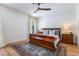 Bright bedroom with a wooden sleigh bed, decorative rug, and ample natural light from a large window at 5351 Carson St, St Cloud, FL 34771