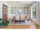 The dining room features a rustic wood table, gallery wall with Gathering photos, and a sliding barn door at 5351 Carson St, St Cloud, FL 34771