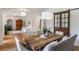 Open dining room with a rustic wood table, modern light fixture, and sliding barn door to the side at 5351 Carson St, St Cloud, FL 34771