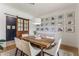 Dining room features a rustic wood table, gallery wall with Gathering photos, and a sliding barn door at 5351 Carson St, St Cloud, FL 34771