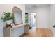 Hallway features a wooden console table with a mirror and a view into another room at 5351 Carson St, St Cloud, FL 34771