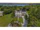 Beautiful exterior elevation of a well-maintained home with a circular driveway, solar panels, and lush landscaping at 5351 Carson St, St Cloud, FL 34771