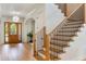 Inviting foyer showcasing a decorative front door, elegant staircase, and hardwood flooring throughout the home at 5351 Carson St, St Cloud, FL 34771