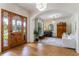 Inviting foyer with decorative wood front door, hardwood floors, and an open floor plan at 5351 Carson St, St Cloud, FL 34771